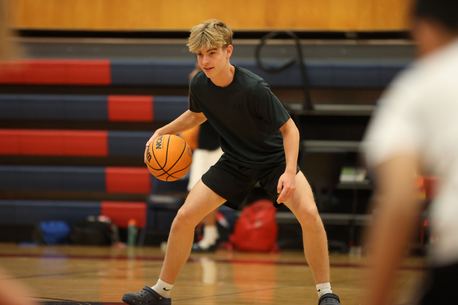 McClintock Charger basketball player showing campers how to do a drill