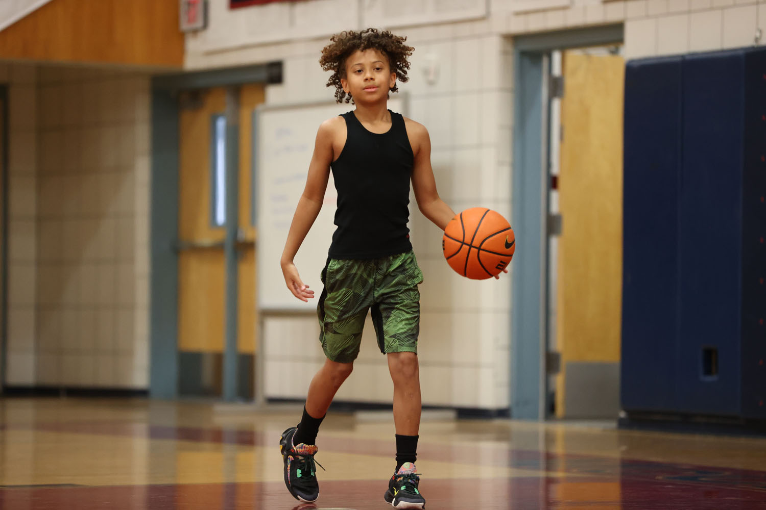 Young Camper dribbling down the court